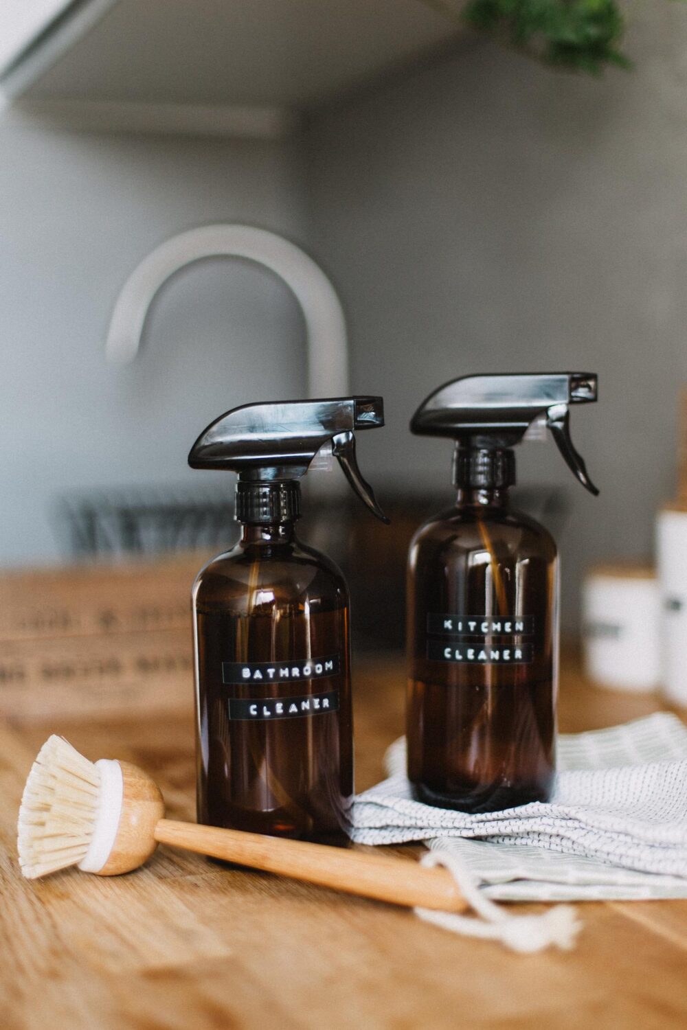 two amber bottles and brush in kitchen